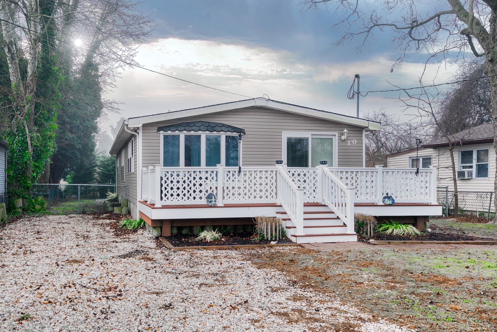 Raised cottage with white lattice deck and front stairs in Villas NJ