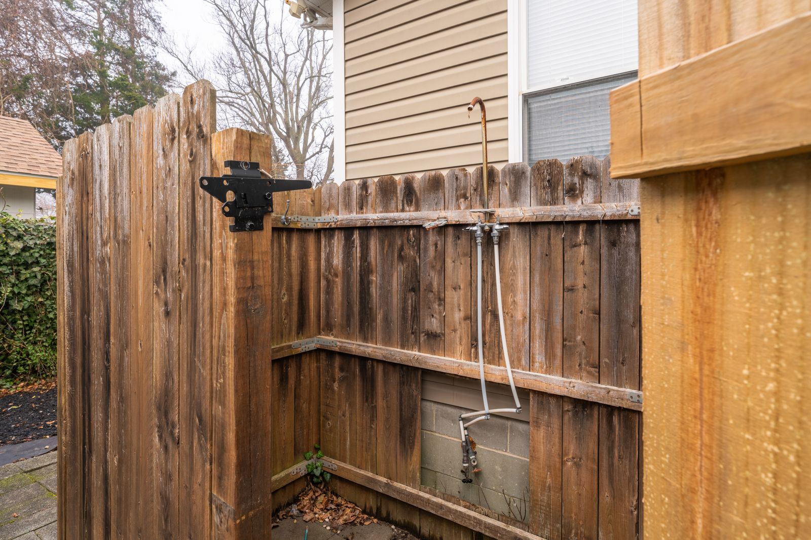 Outdoor shower with wood privacy fence