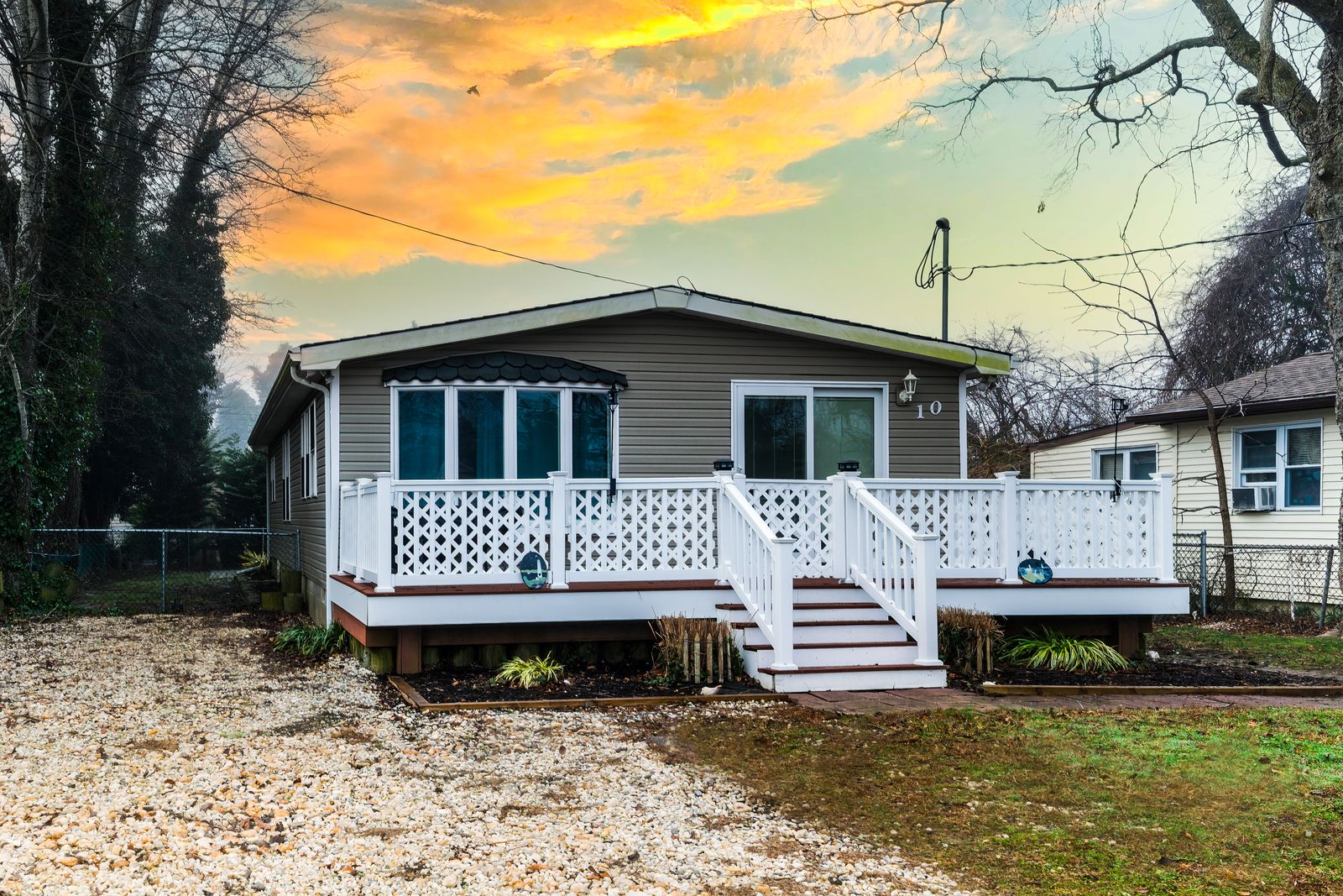 Villas NJ cottage with white deck under a virtual twilight sky