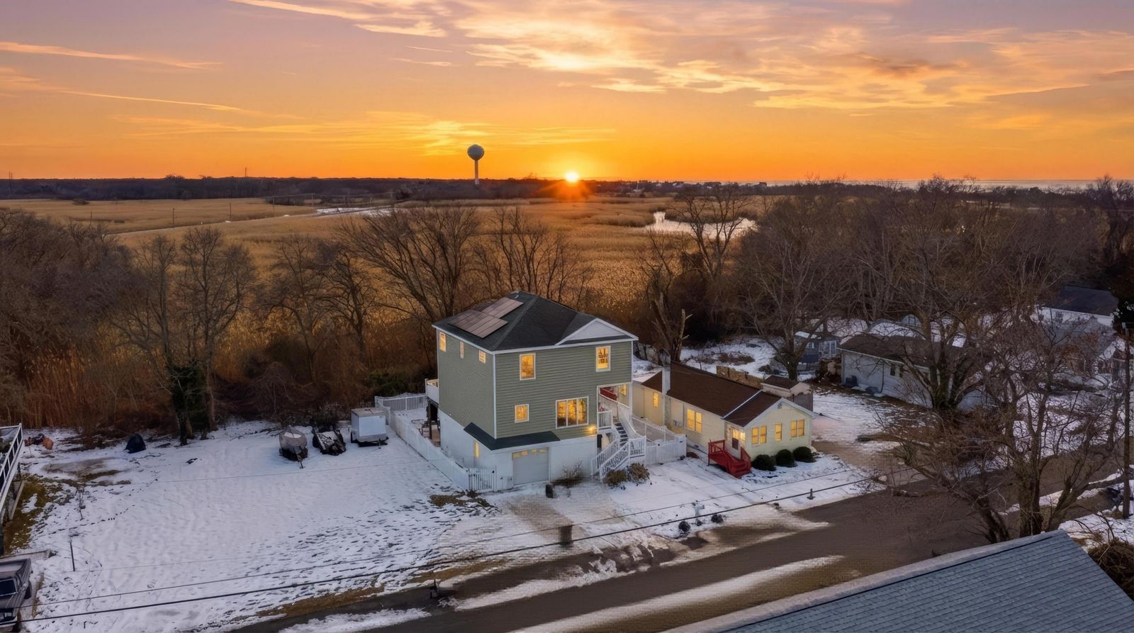 Drone aerial at sunset over the home and the bayside marsh