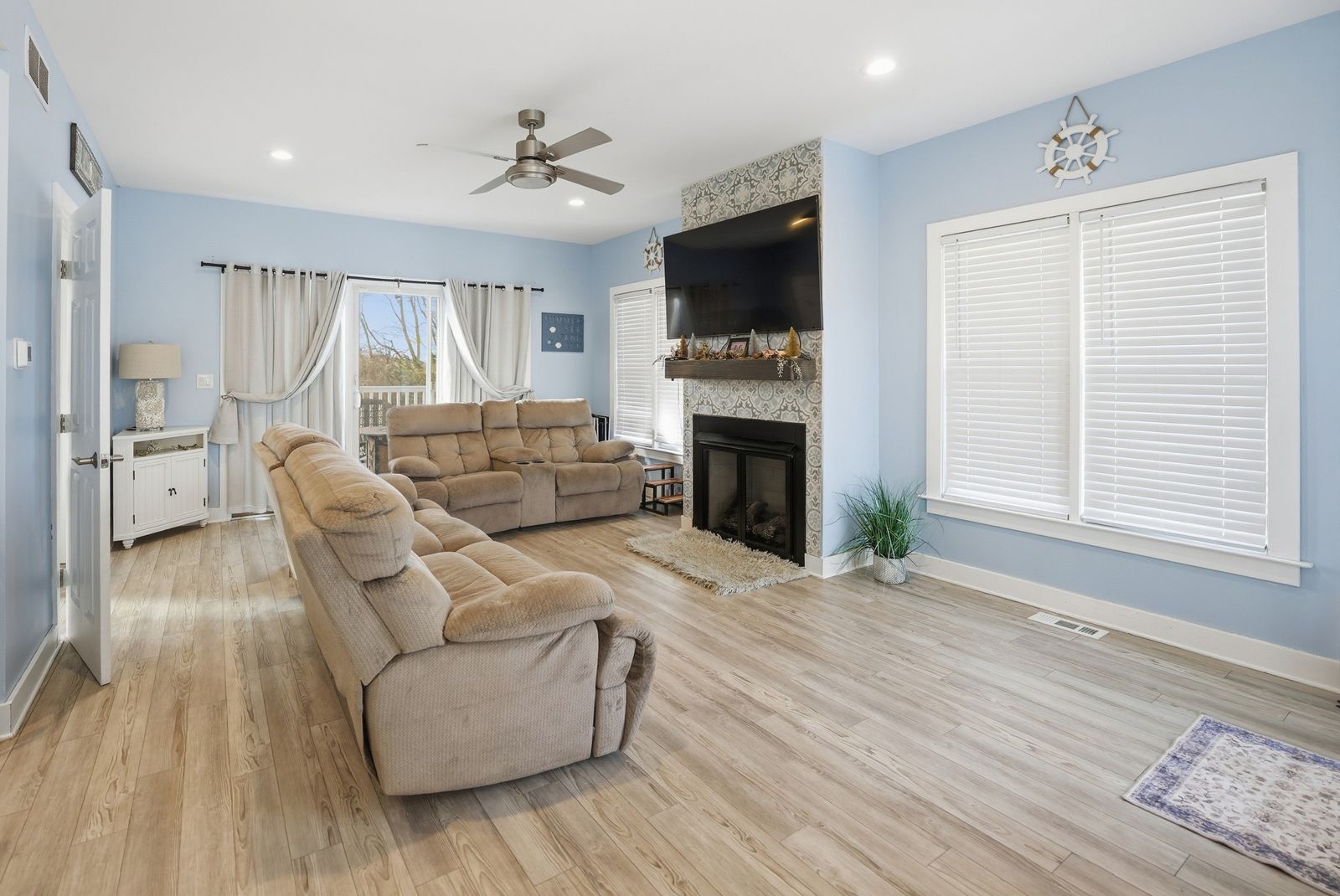 Light blue living room with fireplace and two sofas