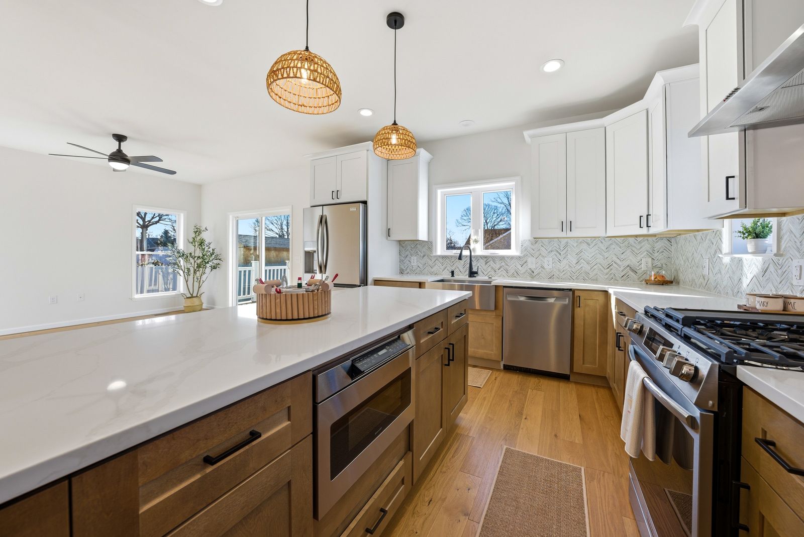 Kitchen with white and walnut cabinets and quartz island