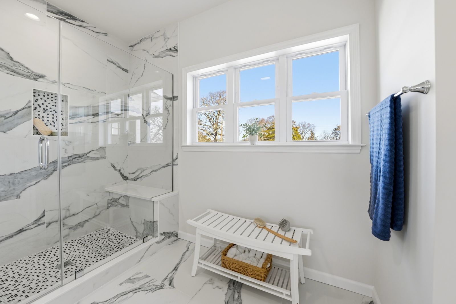 Marble walk-in shower with bench