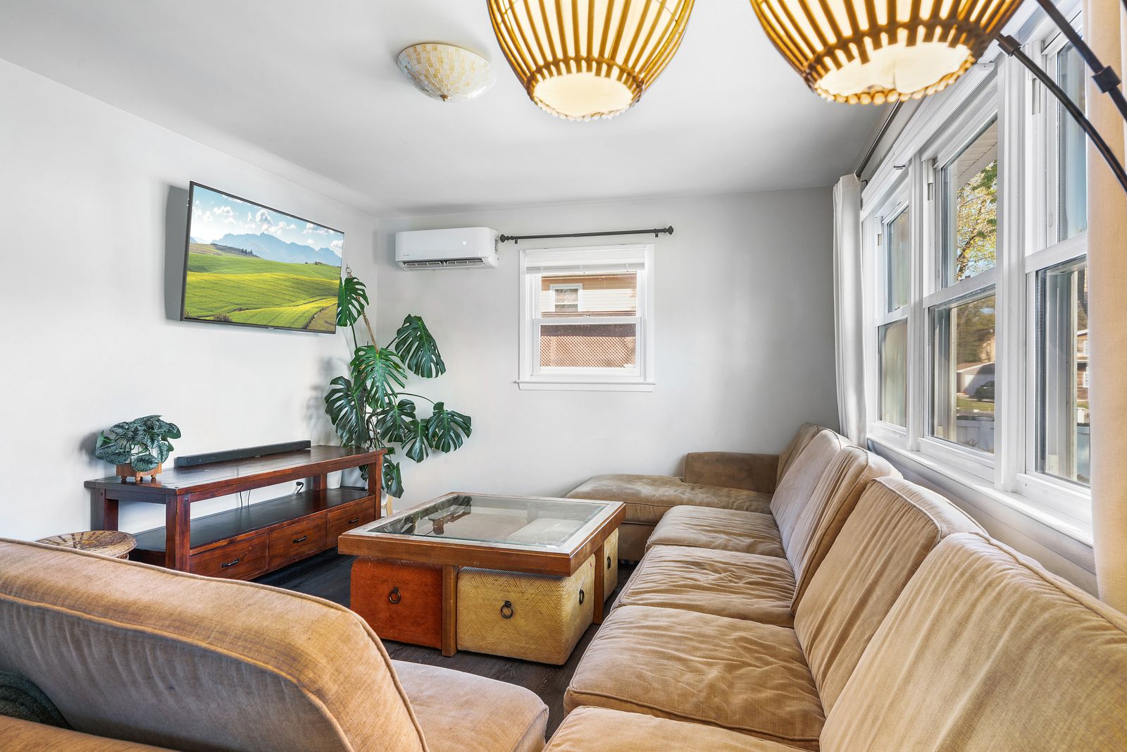 Living room with sectional sofa and rattan pendant lights