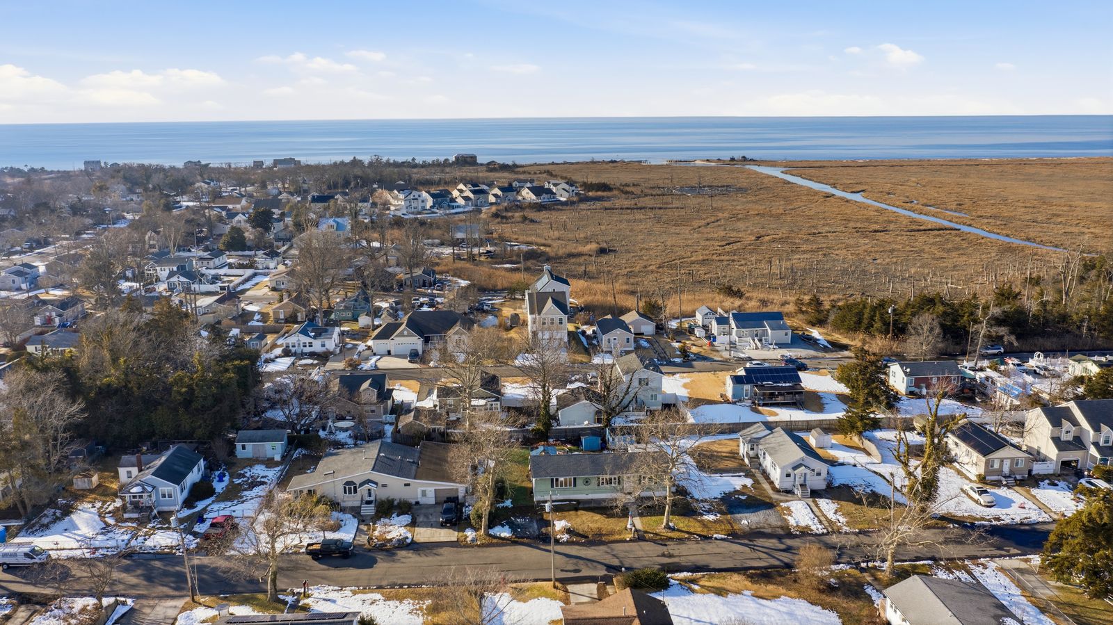 Drone aerial over Villas NJ toward the Delaware Bay and marsh