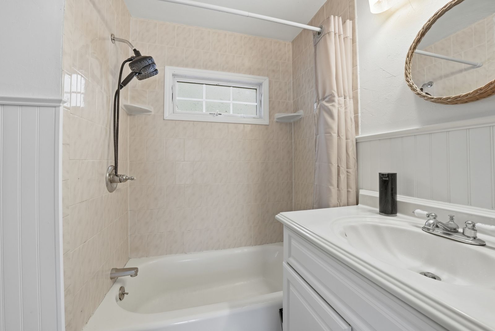 Bathroom with tub and wainscoting