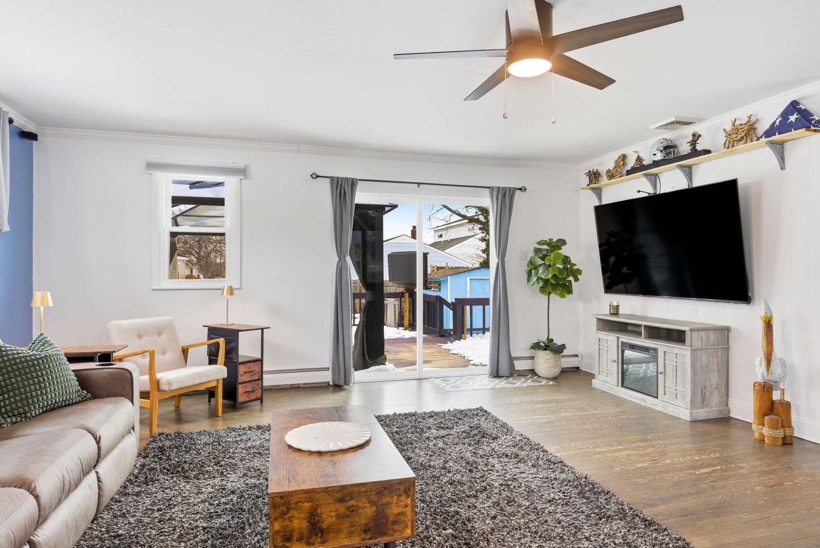 Living room with fireplace TV wall and sliding door