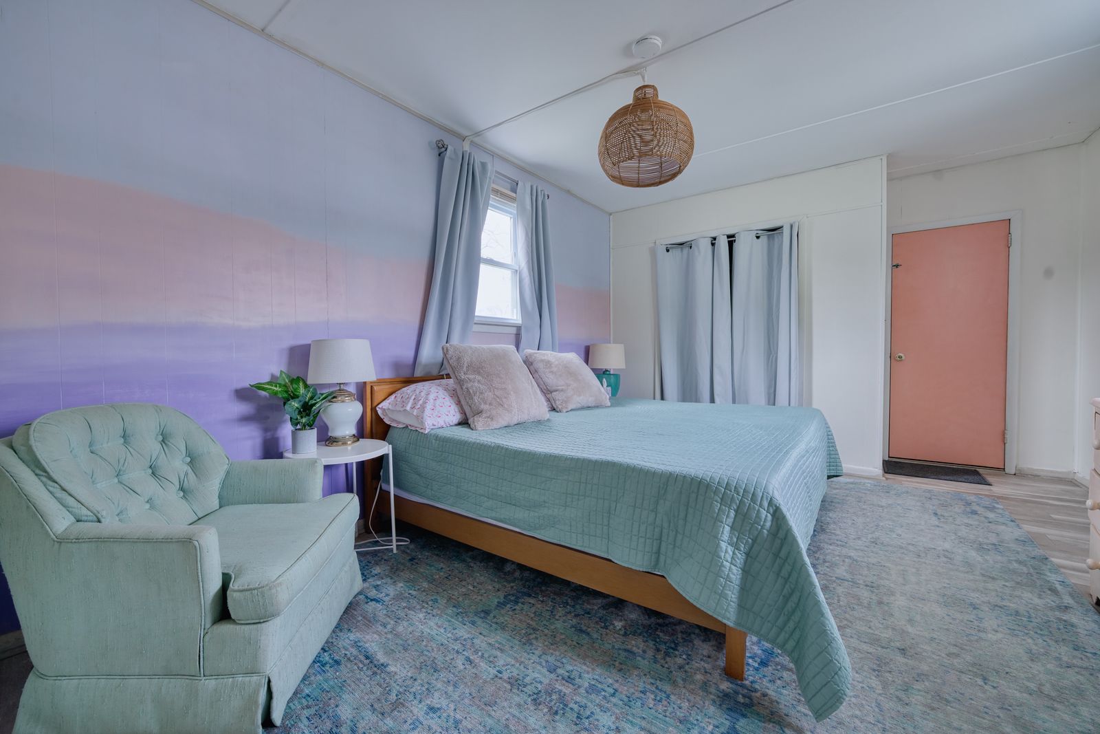 Bedroom with purple ombre accent wall