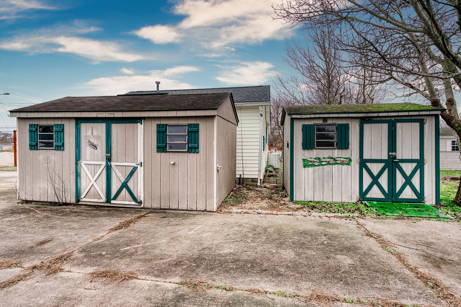 Two storage sheds by the driveway