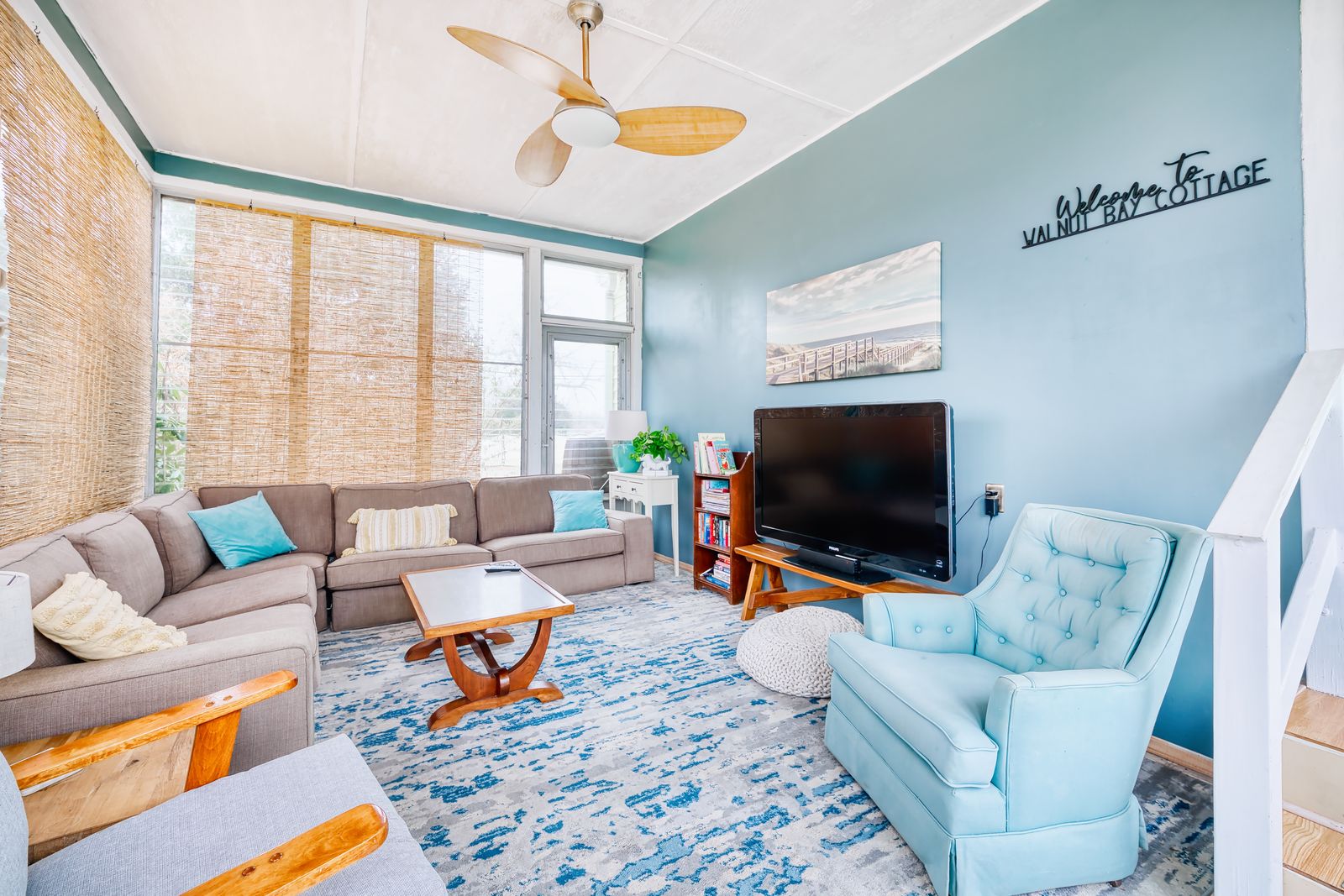 Sunroom family room with sectional and coastal decor