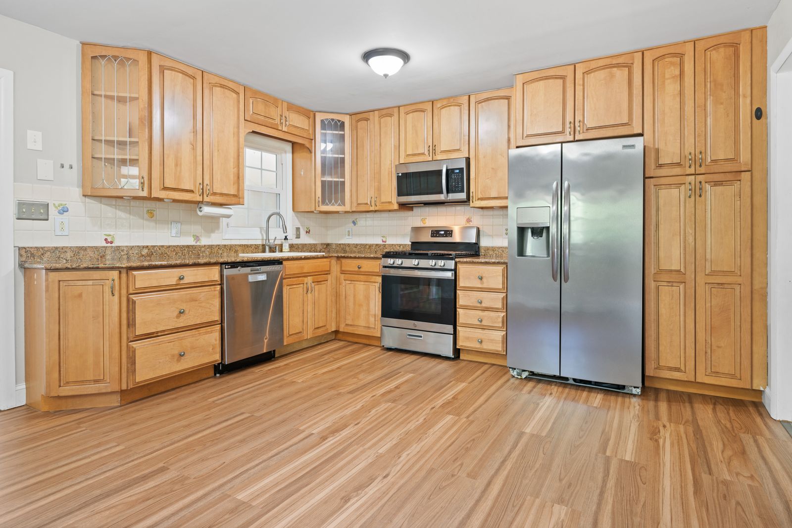 Maple kitchen with granite counters and stainless appliances