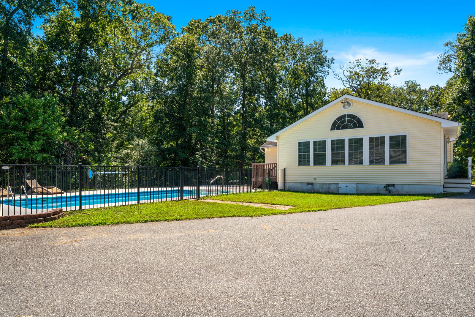 Back of the home with fenced inground pool