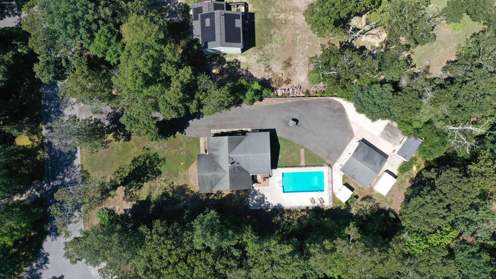 Top-down drone view of the home, pool and garage