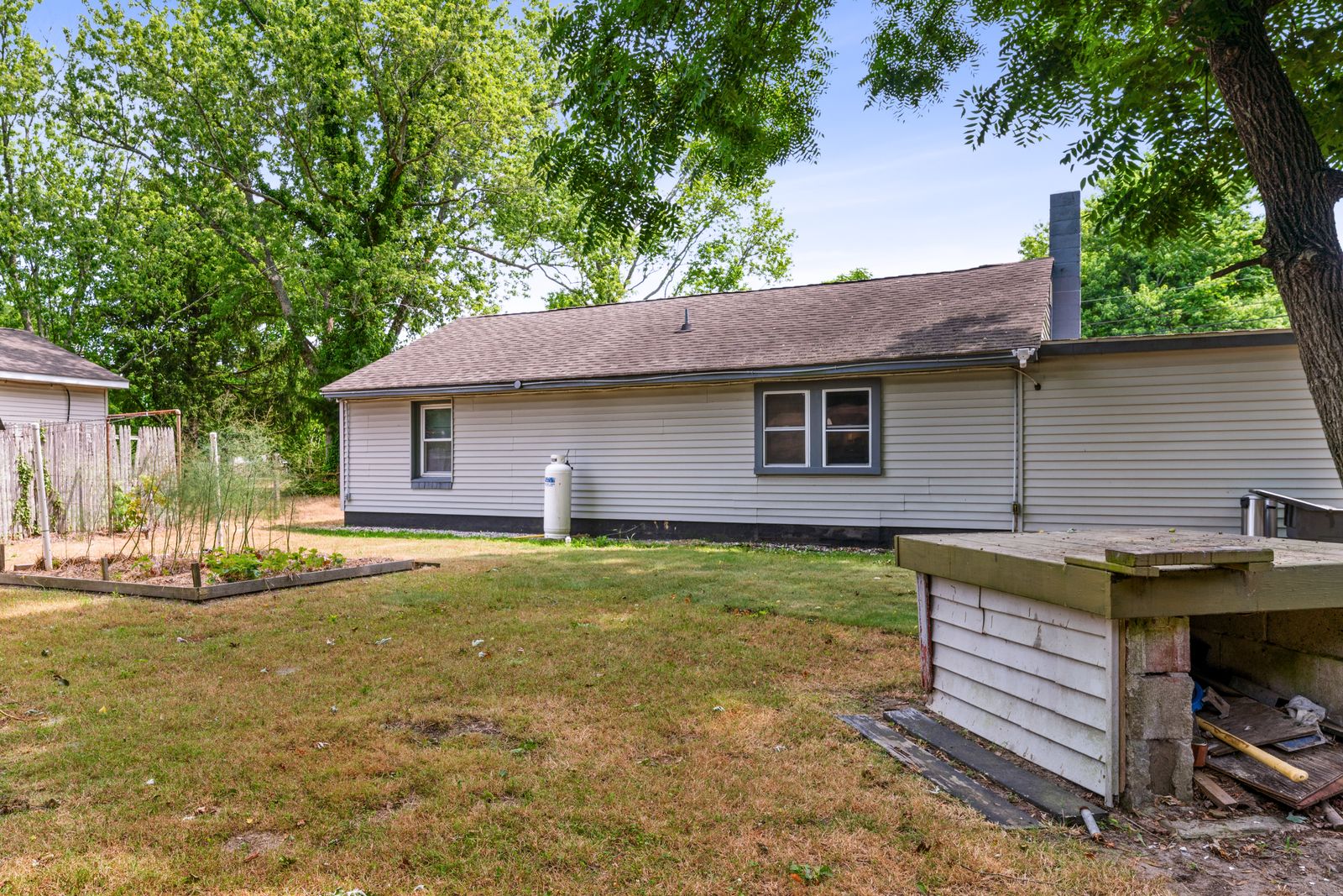 Back of the home with raised garden beds