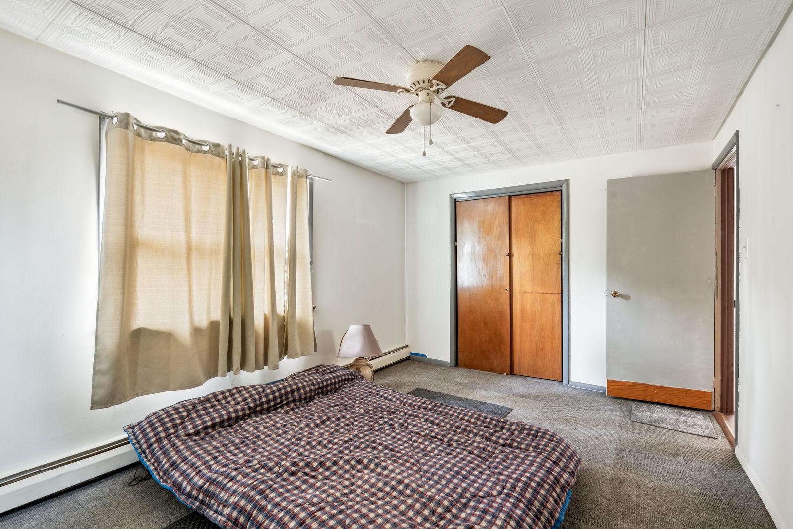 Bedroom with ceiling fan and double closet