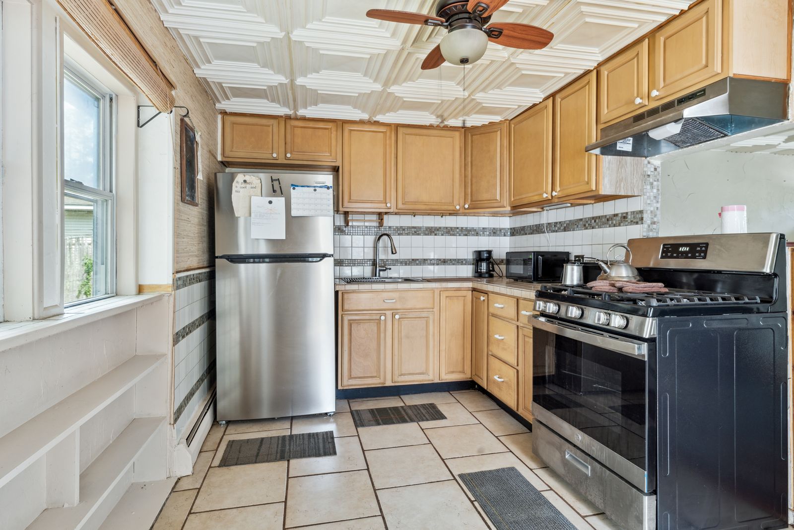 Kitchen with light wood cabinets and stainless appliances