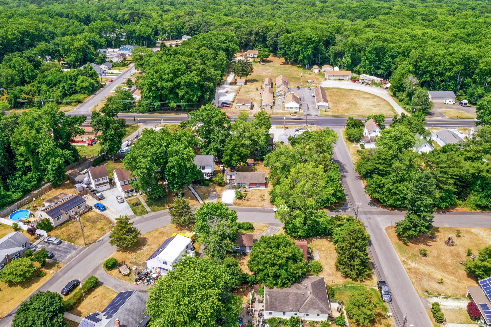 Wide drone aerial over the wooded Cape May NJ neighborhood