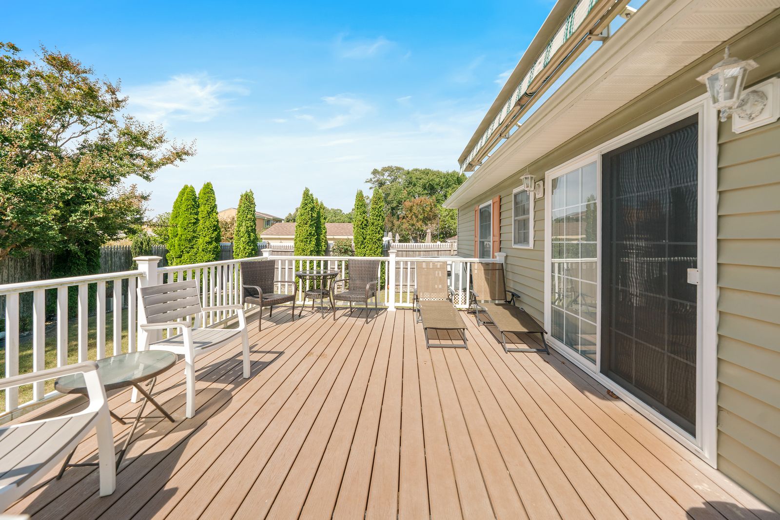 Back deck with sliding doors and lounge chairs