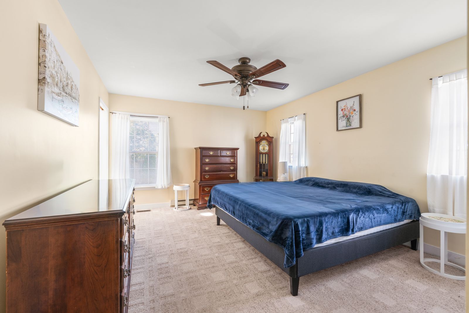 Bedroom with ceiling fan and dark wood furniture