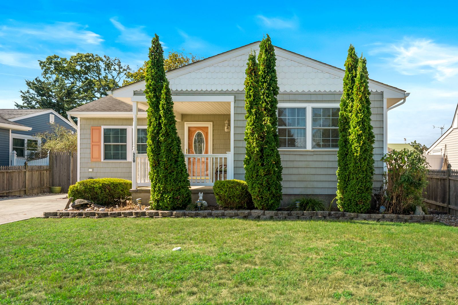Ranch home with front porch and Italian cypress trees in Villas NJ