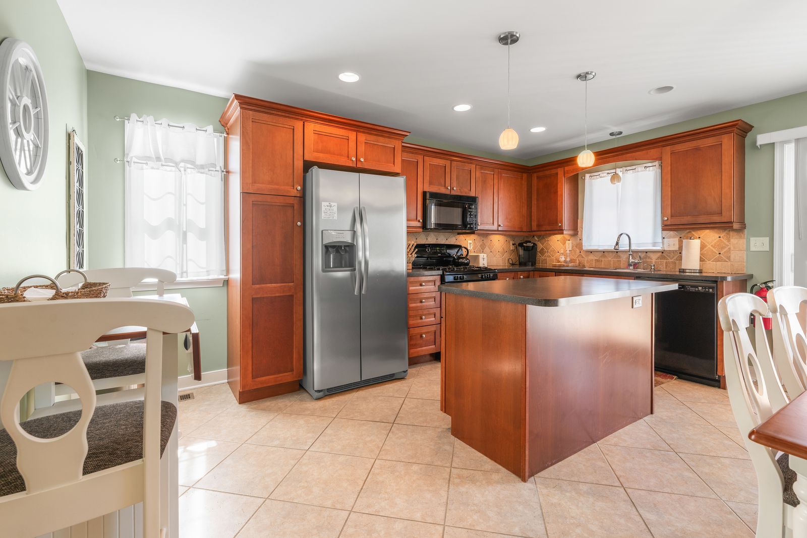 Cherry kitchen with island and stainless appliances