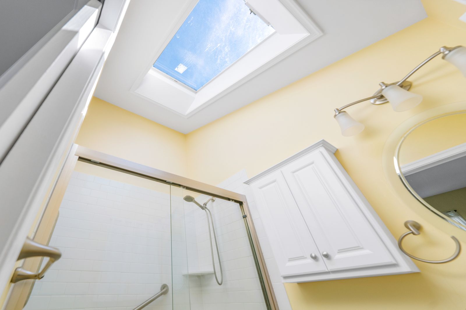 Bathroom with skylight and glass shower