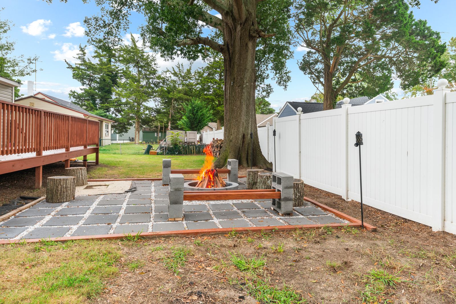 Backyard patio with fire pit and privacy fence