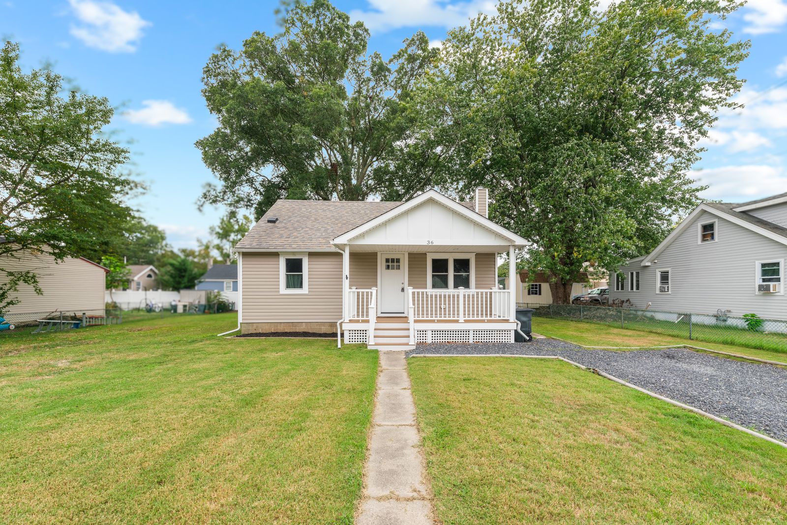 Renovated cottage with white front porch on a big lawn in Villas NJ