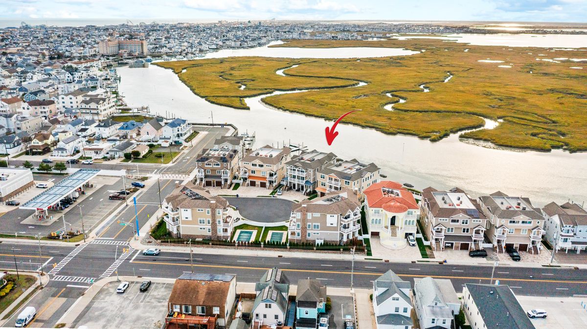 An arrow marks the home between the marsh and the bay