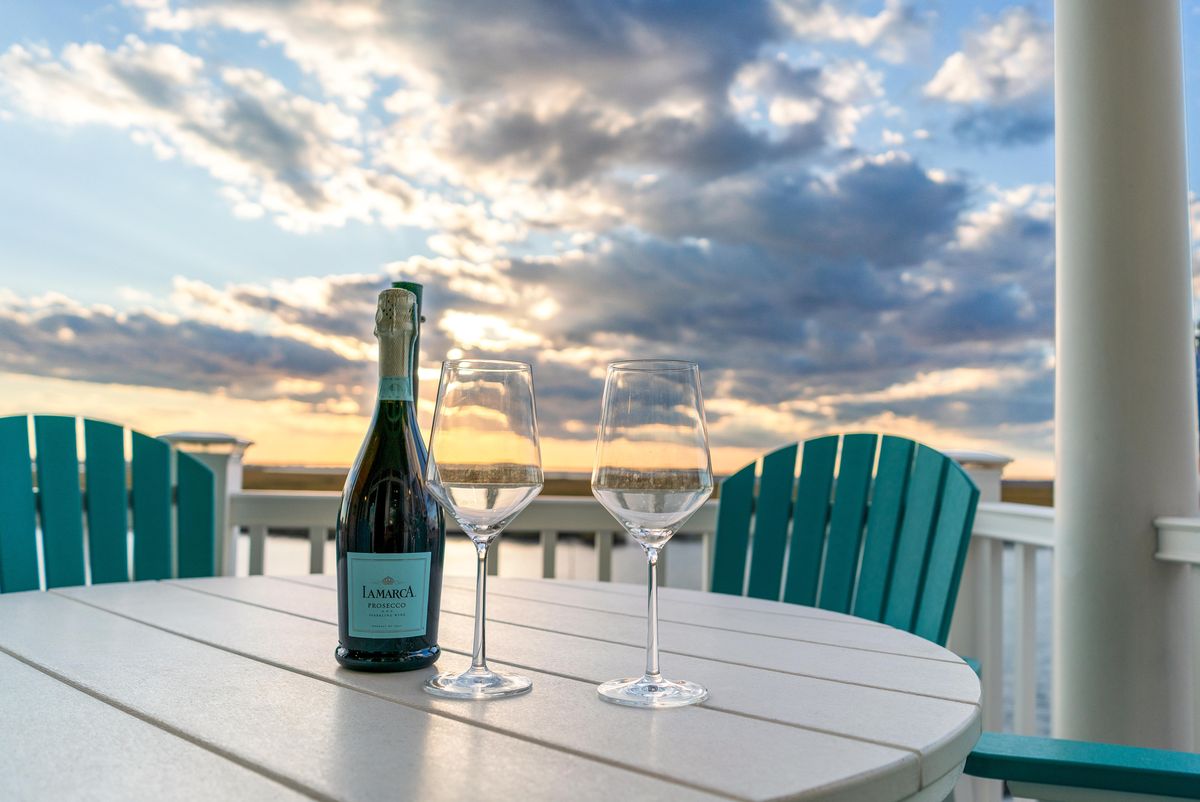 Prosecco and two glasses on the balcony at sunset