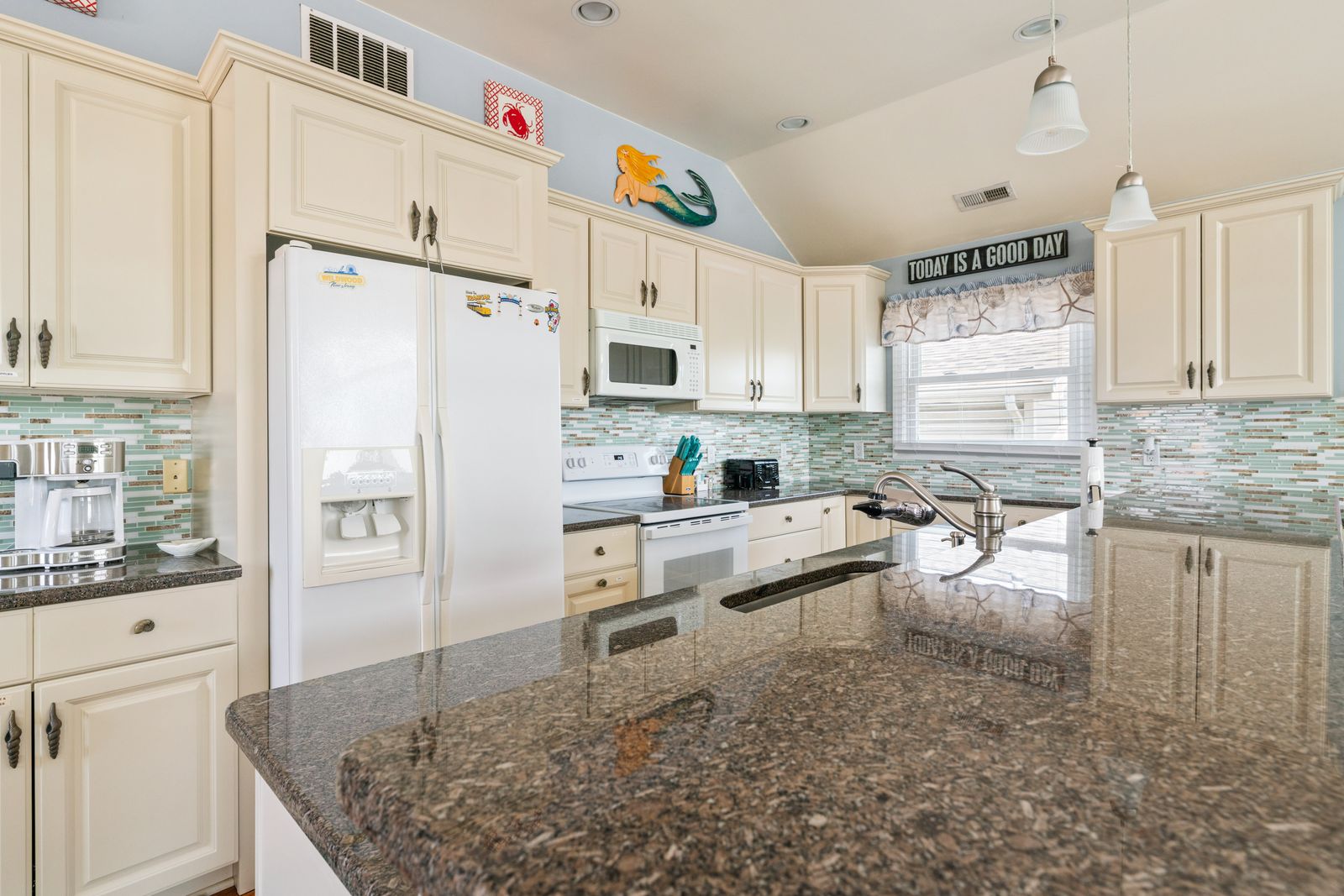 White kitchen with granite island