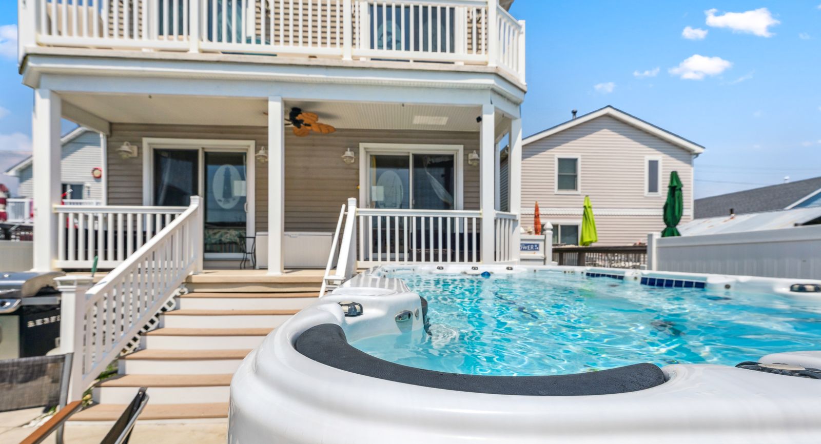 Backyard swim spa with steps to the deck