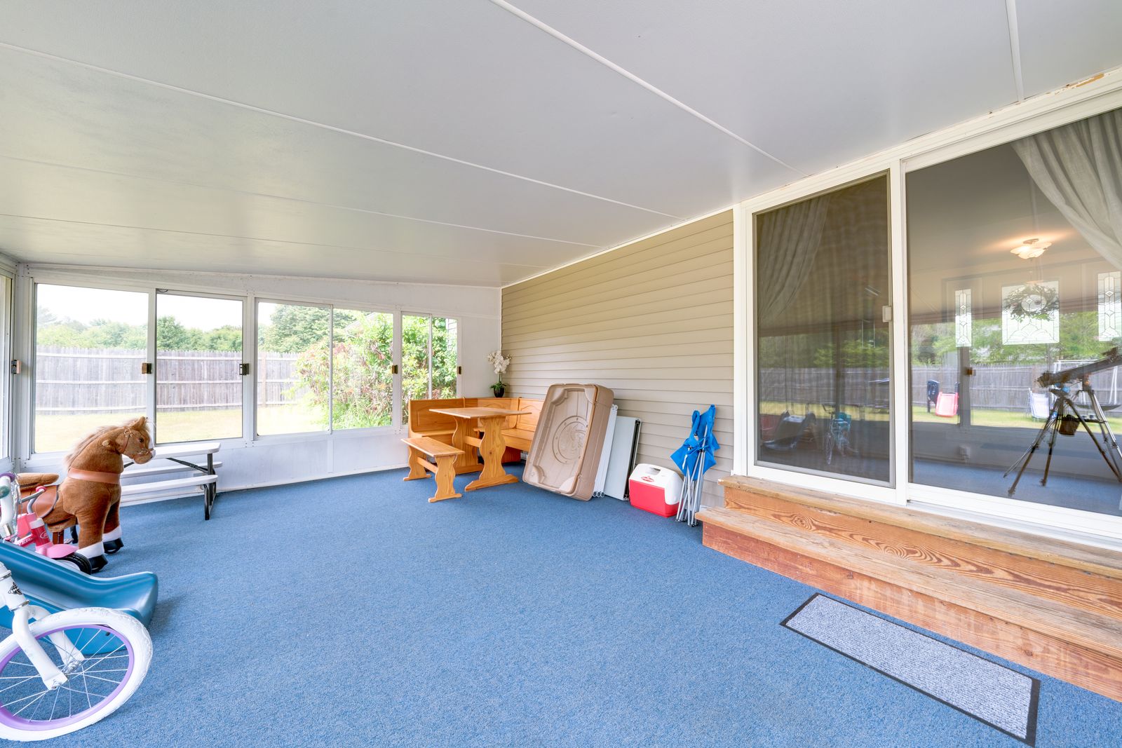 Enclosed sunroom overlooking the backyard