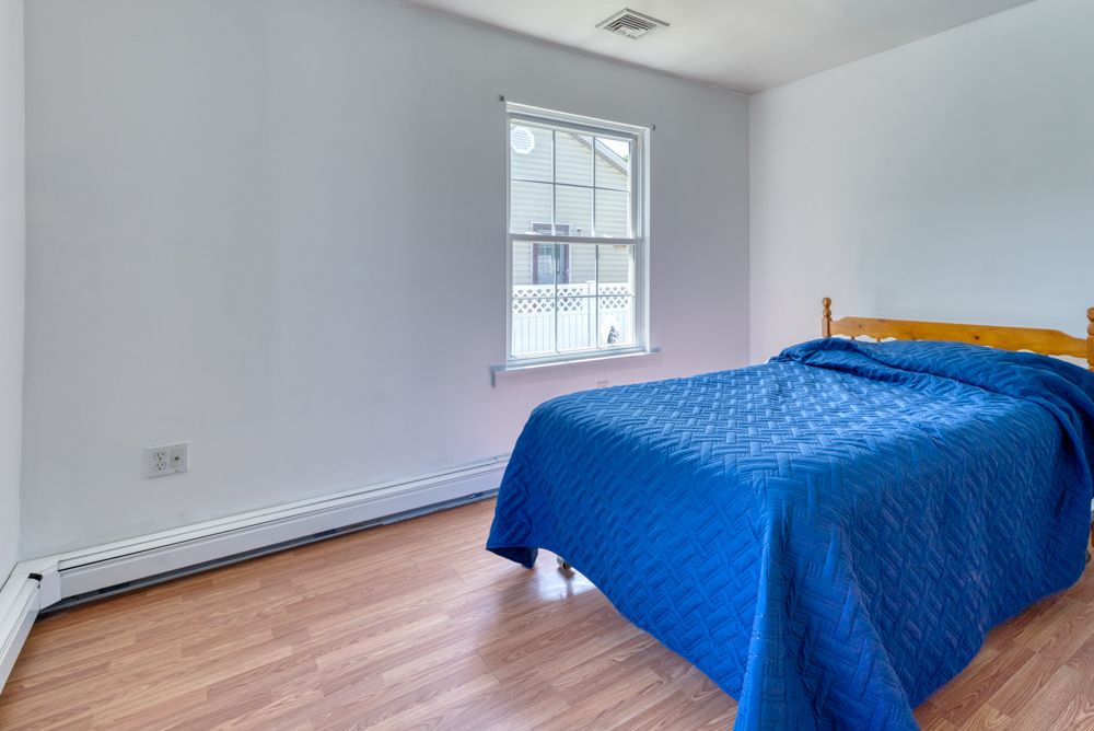Bedroom with ceiling fan and two windows
