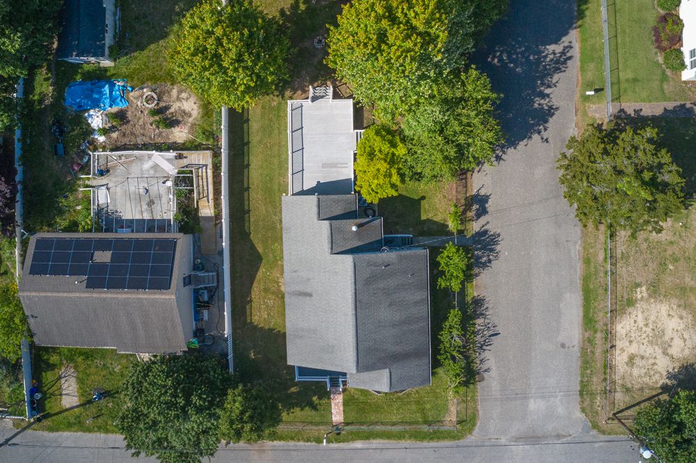 Top-down drone view of the lot, deck and garage