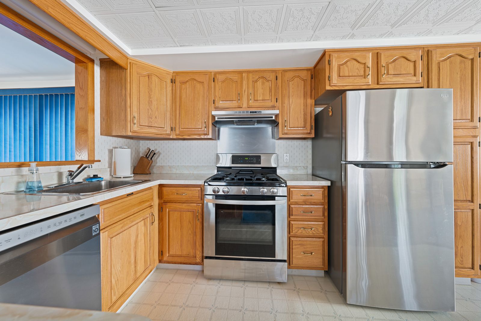 Oak kitchen with stainless appliances and gas range