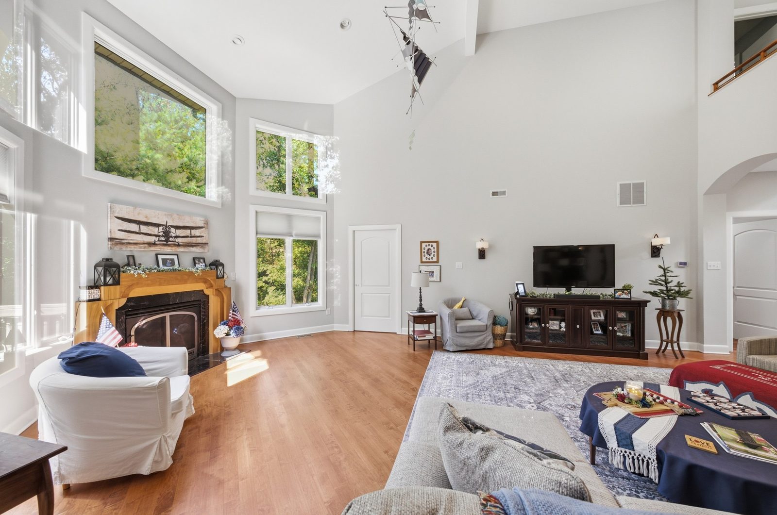 Bright great room with fireplace and tall windows