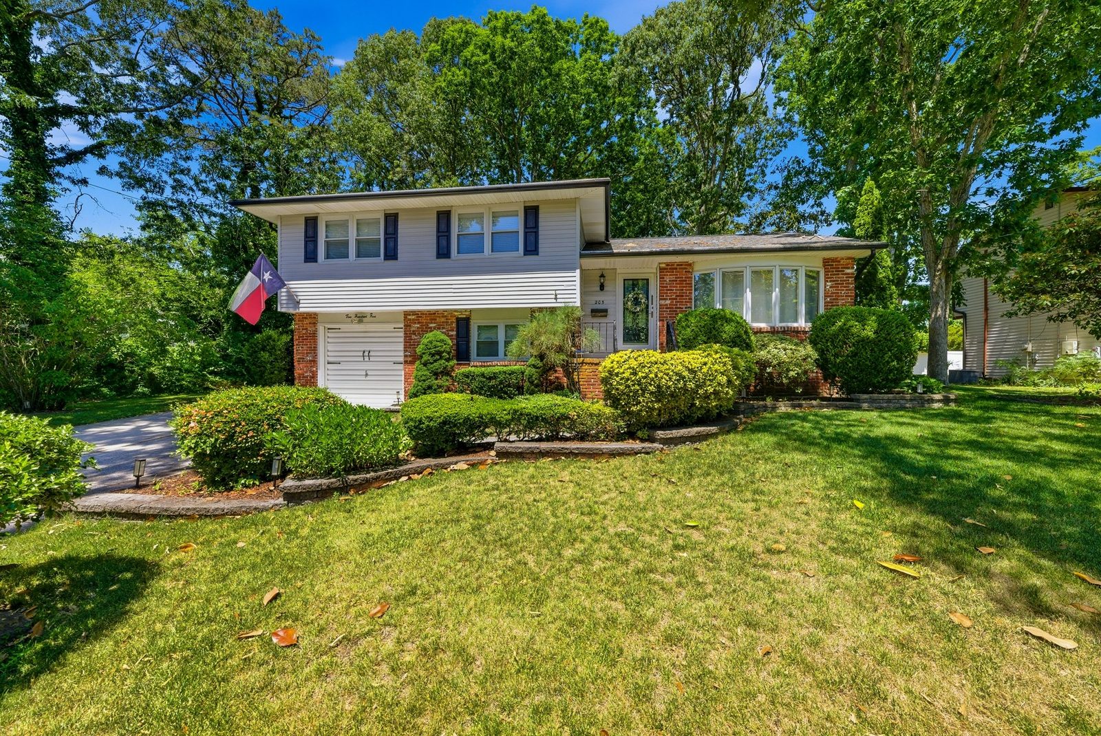 Two-story Somers Point NJ home with garage and lawn