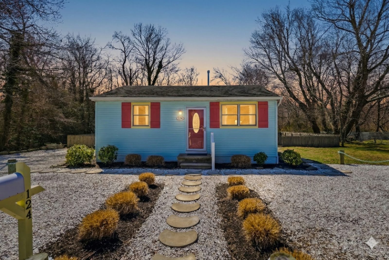 Light blue Villas NJ cottage with red shutters at twilight