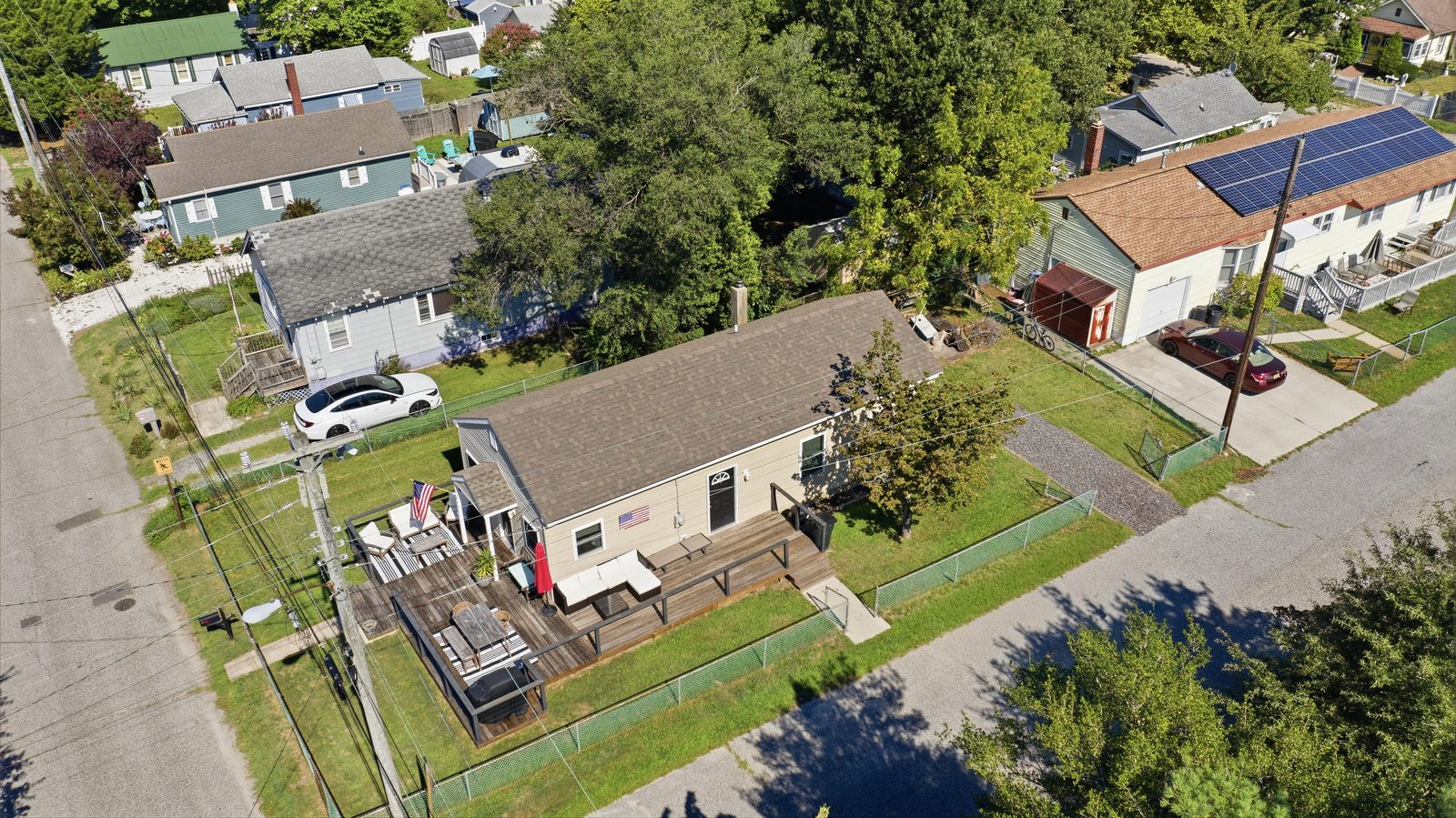 Drone aerial view of a beige bungalow with deck in Villas NJ