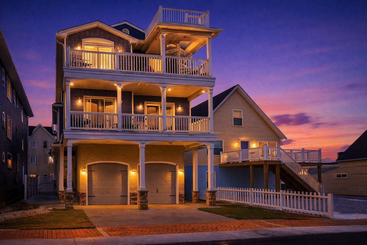 Wildwood, NJ home glowing at twilight under a purple and pink dusk sky