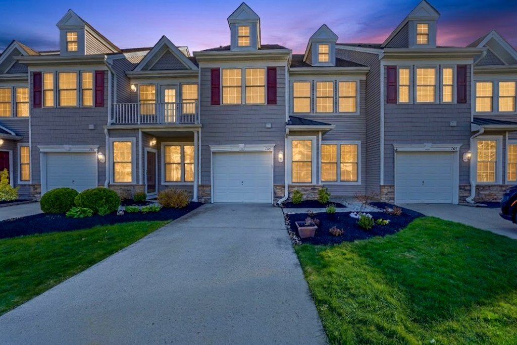 Townhome exteriors glowing at dusk in Cape May Court House NJ